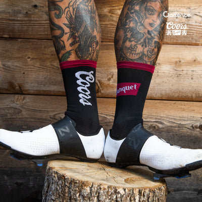  Coors Banquet Socks  [Black]  • Cadence logo at rear of sock  • 6" Cuff  • 60% Nylon, 39% COOLMAX® EcoMade, 1% Lycra®  • Made in USA  • Available in four sizes  • Small fits sizes 4.5 - 6.5 | Medium fits sizes 7 - 9 | Large fits 9.5 - 11.5 | X Large fits 12 - 14  THIS LICENSED PRODUCT IS INTENDED FOR ADULTS OF LEGAL DRINKING AGE  @Coors Brewing Company. All Rights Reserved |Produced Under License by Cadence Collection