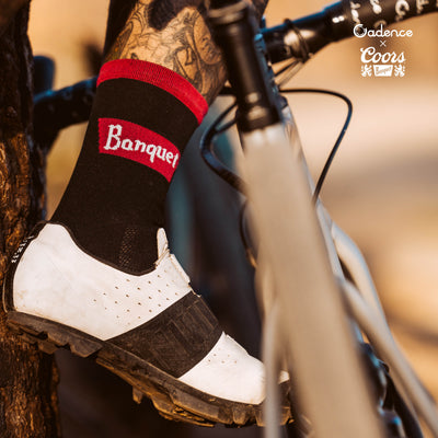  Coors Banquet Socks  [Black]  • Cadence logo at rear of sock  • 6" Cuff  • 60% Nylon, 39% COOLMAX® EcoMade, 1% Lycra®  • Made in USA  • Available in four sizes  • Small fits sizes 4.5 - 6.5 | Medium fits sizes 7 - 9 | Large fits 9.5 - 11.5 | X Large fits 12 - 14  THIS LICENSED PRODUCT IS INTENDED FOR ADULTS OF LEGAL DRINKING AGE  @Coors Brewing Company. All Rights Reserved |Produced Under License by Cadence Collection